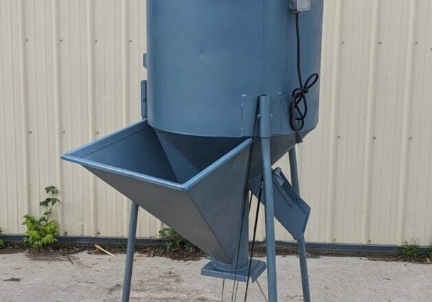 A blue bin sitting on top of a wooden floor.